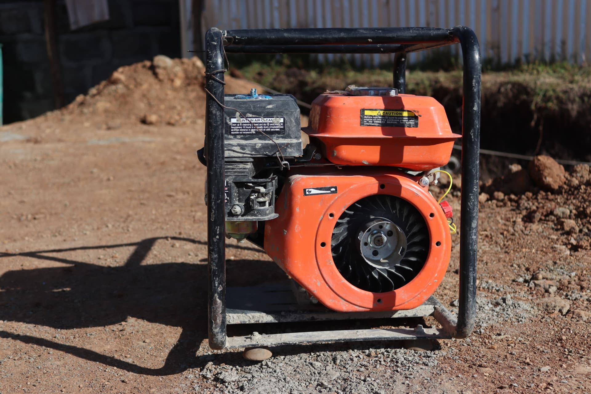 Petrol-driven water pump in a roll cage on a FIIDE site